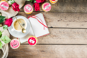 Valentine morning sweetheart scene. Breakfast on Valentine's Day February 14th. Sweet creative cupcakes with whipped cream and decor love, Valentine symbols. Mockup flatlay top view copy space
