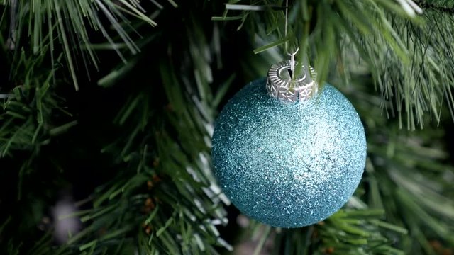 Shiny blue Christmas ball hanged by holiday season 4K video