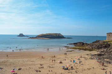 rocky beaches of northern france with people swimming and sunbathing