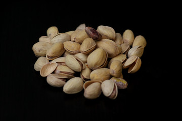pistachio nuts isolated on black background