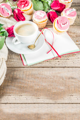 Valentine morning sweetheart scene. Breakfast on Valentine's Day February 14th. Sweet creative cupcakes with whipped cream and decor love, Valentine symbols. Mockup flatlay top view copy space