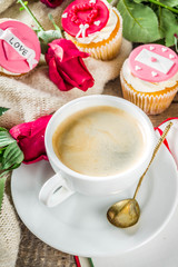 Valentine morning sweetheart scene. Breakfast on Valentine's Day February 14th. Sweet creative cupcakes with whipped cream and decor love, Valentine symbols. Mockup flatlay top view copy space