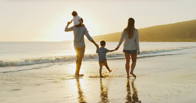 A golden family sunset beach walk