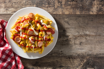 Typical Latin America Salchipapa. Sausages with fries, ketchup. Top view. Copy space