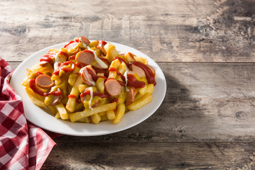 Typical Latin America Salchipapa. Sausages with fries, ketchup. Copy space