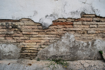 The white wall broke inside of the orange bricks.