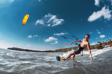 Real wakeboarder with kite at sea bay
