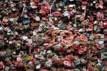 Full frame close-up view of a section of a huge a alley wall plastered with used chewing gum