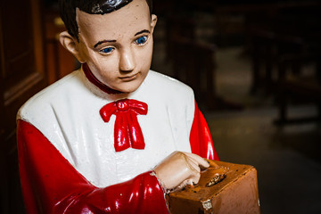 acolyte with collecting box for gifts in church