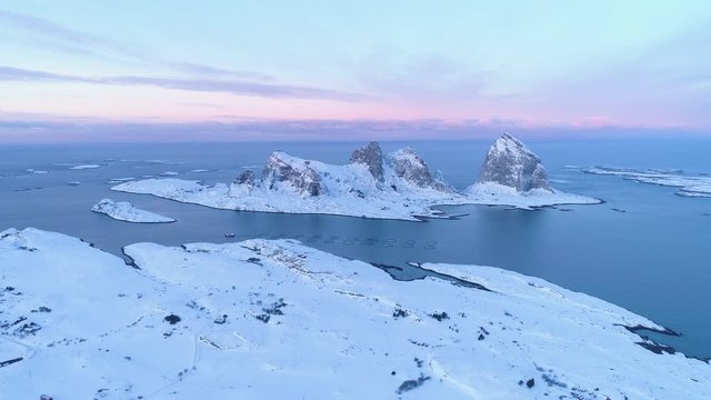 Winter in Tr&aelig;na, iconic mountains of Sanna island, salmon farm, Nordland, Northern Norway, aerial drone shot