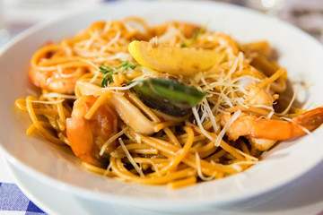 Delicious seafood pasta with cheese close up
