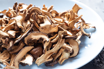 braune geschnittene gesammelte getrocknete Pilze auf grauem Grund im Herbst