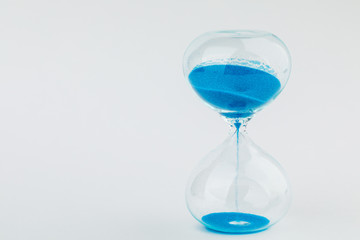 Hourglass as a concept of passing time. On white background