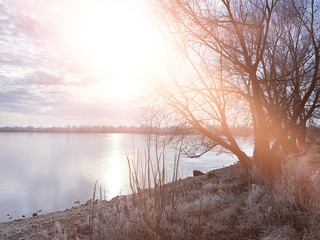 Winter landscape, landscape with a river and sunny sunset. Natural background, winter background.