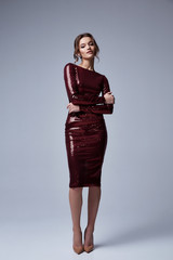 Beautiful sexy woman wear lux skinny red dress shiny sequins style for party celebrate New Year...