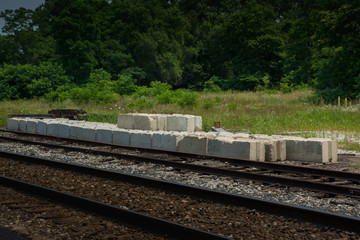 Fototapeta premium Concrete blocks for repair staged next to a railroad