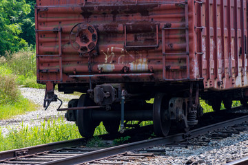Close-up of rusty boxcar wheels on railroad siding