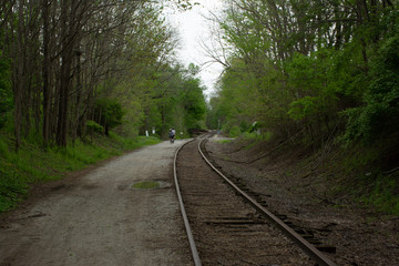 Bicyclist on path next to railroad tracks