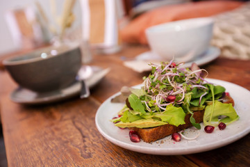 Healthy salad on wooden table in cozy café