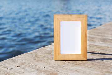 Wooden photo frame in front the seaside