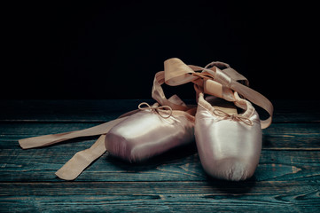 Pointes ballet shoes. Against a dark background.