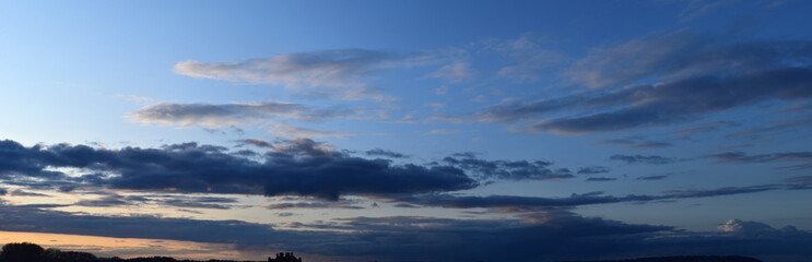 Fototapeta na wymiar Evening cloudy sky. Autumn atmospheric phenomenon, panoramic photography, mid-September.