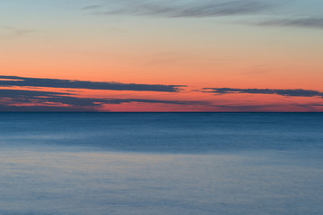 sunset on a calm sea with saturated colors background