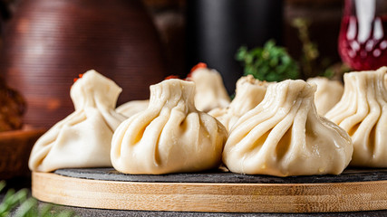 National Georgian cuisine. Khinkali with meat. Khinkali on a wooden board close-up.