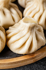 National Georgian cuisine. Khinkali with meat. Khinkali on a wooden board close-up.