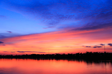 Fototapeta na wymiar Fantasy abstract twilight dawn background, Gold sunlight on blue sky and moving soft purple clouds above before sunset-Mae khong river, Thailand