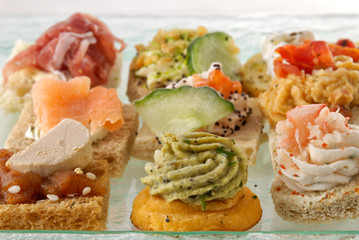 Assortment of various appetizer canapes on plate