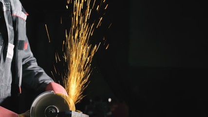 Forge workshop. Smithy manual production. Close up details of sparks, industrial worker using angle...