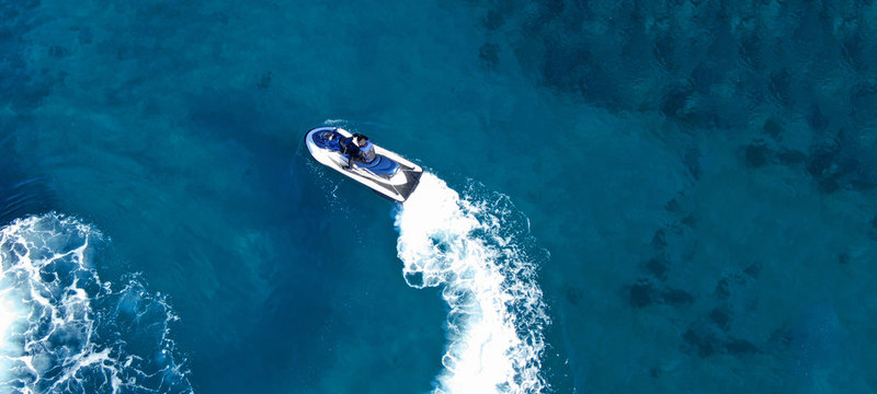Aerial drone ultra wide top view photo of jet ski water crafts cruising in deep blue Mediterranean sea