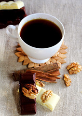 A cup of coffee. White dishes. Coffee and chocolate. Morning ritual.