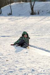 Fototapeta na wymiar Boy Sliding on Ice Rink