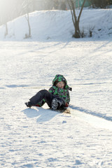Fototapeta na wymiar Boy Sliding on Ice Rink