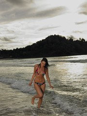 Bikini Woman Walking In Water At Beach