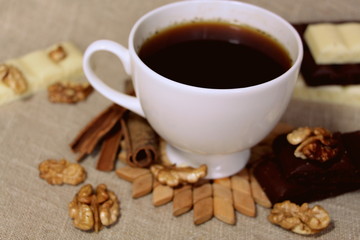 A cup of coffee. White dishes. Coffee and chocolate. Morning ritual.