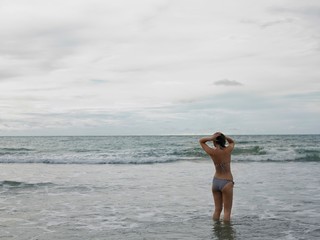 Woman In Bikini Walking In Ocean