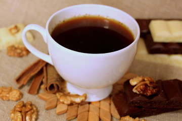 A cup of coffee. White dishes. Coffee and chocolate. Morning ritual.