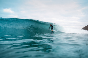 surfer riding waves on the island of fuerteventura