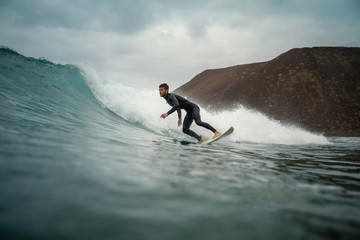 surfer riding waves on the island of fuerteventura