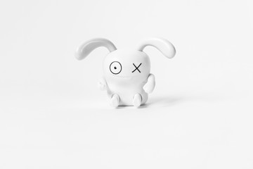 Figure of a funny white rabbit on a white background