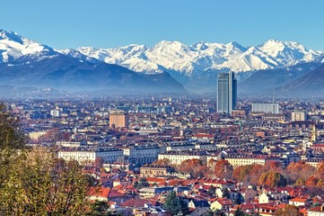 Modern and ancient architecture in Turin skyline, in a clear winter morning with snowy Alps on background