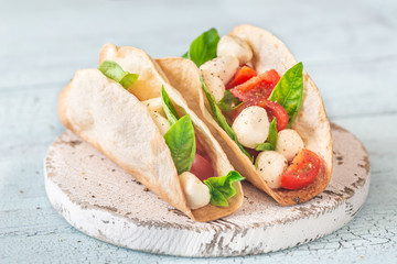 Caprese taco on the wooden table