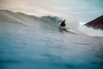 Naklejka premium surfer riding waves on the island of fuerteventura