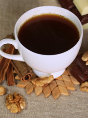 A cup of coffee. White dishes. Coffee and chocolate. Morning ritual.