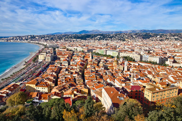Panoramic view on a winter morning with blue sky on the Nice waterfront, Promenade Des Anglais, and old town, from the castle garden