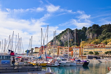 Fototapeta na wymiar Nice, France - December 02, 2019: View of the commercial Lympia port in a clear winter morning, with the Castle hill on the background