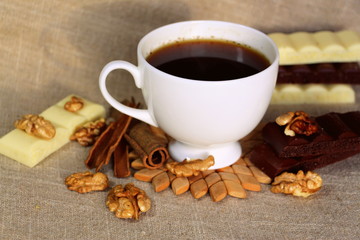 A cup of coffee. White dishes. Coffee and chocolate. Morning ritual.